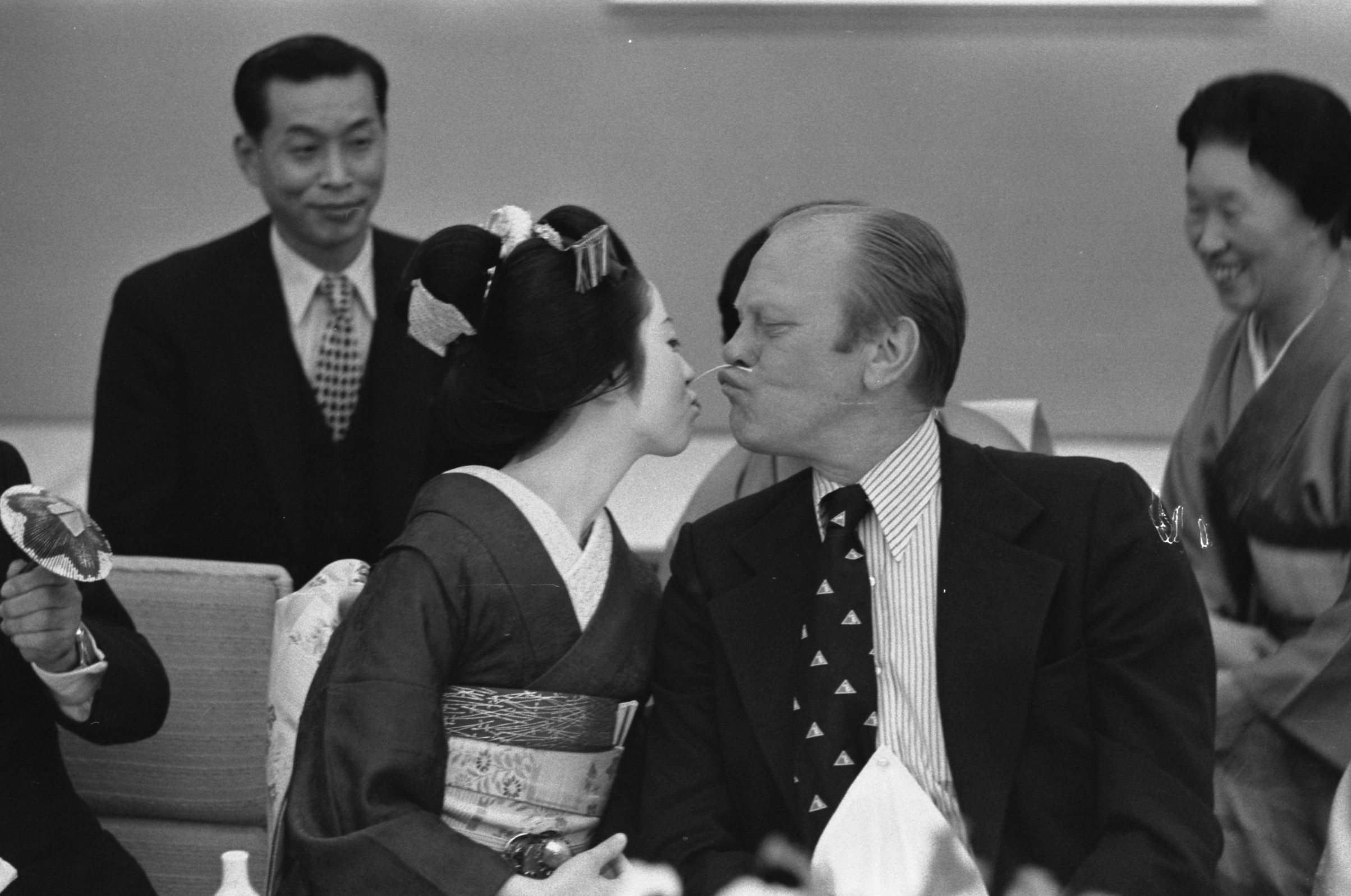 President Gerald Ford plays a traditional Japanese game with a geisha, while on a state visit to Kyoto, Japan. November 21, 1974. 